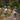 Two children with bicycles on a path surrounded by greenery